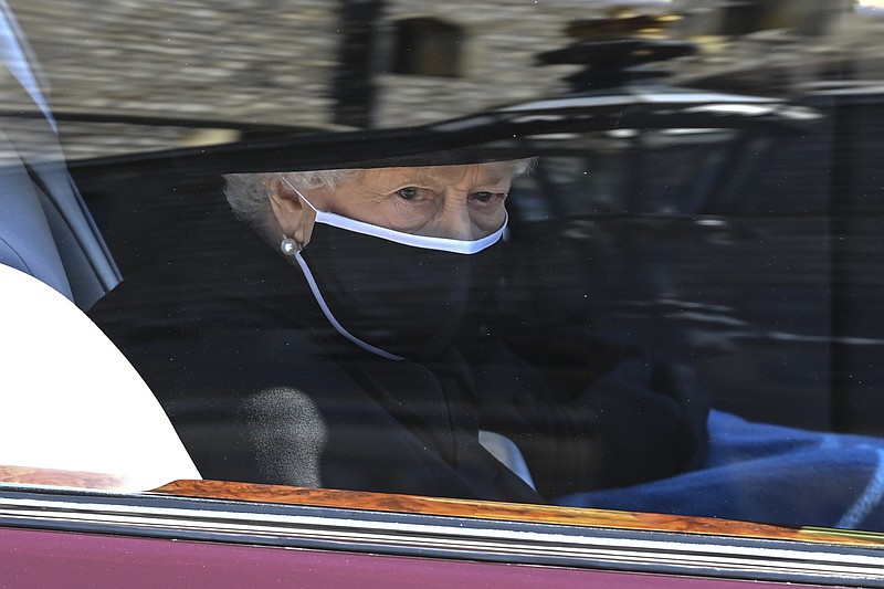 Prince Philip is laid to rest as somber queen sits alone